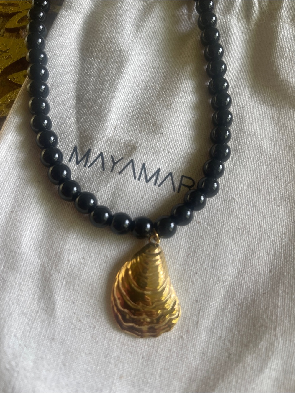 Gold Shell Pendant on Black Beaded Necklace